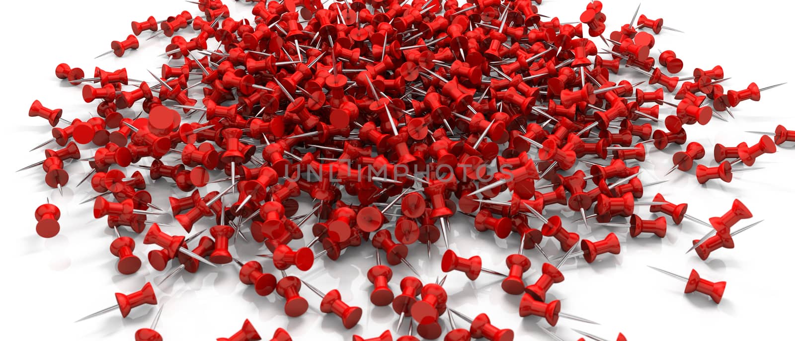 a bunch of red drawing/push pins scattered over a white surface