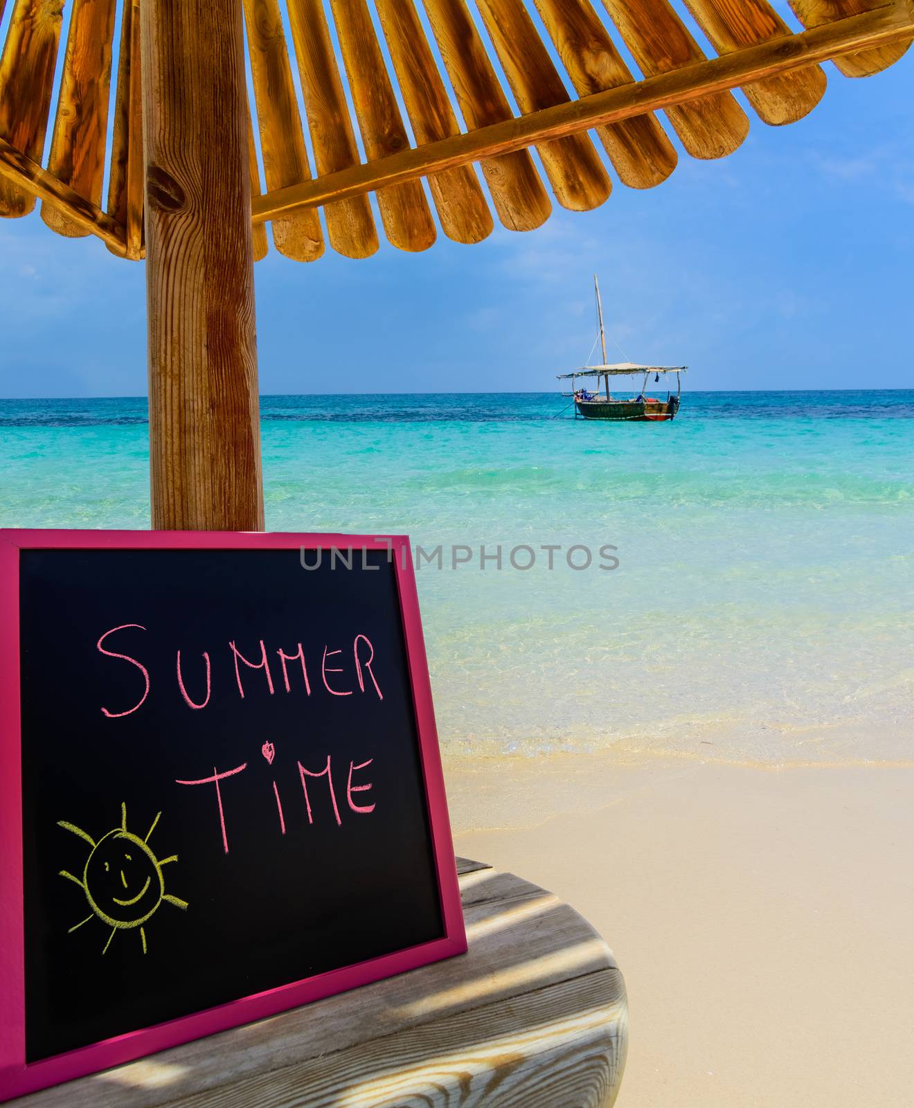 In the picture a Zanzibar beach which is a small blackboard with the words " Summer Time" in the afternoon .