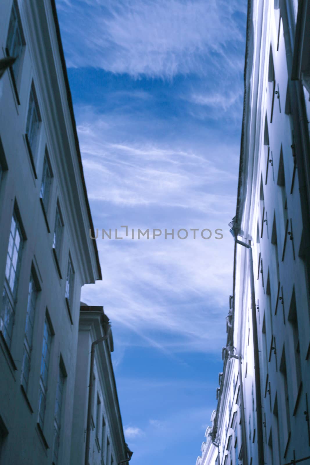 Side of buildings and sky on narrow street
