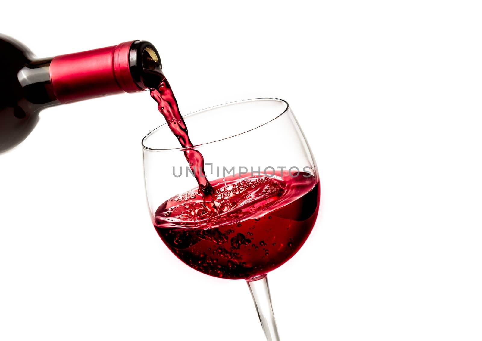 barman pouring red wine in the glass on white background