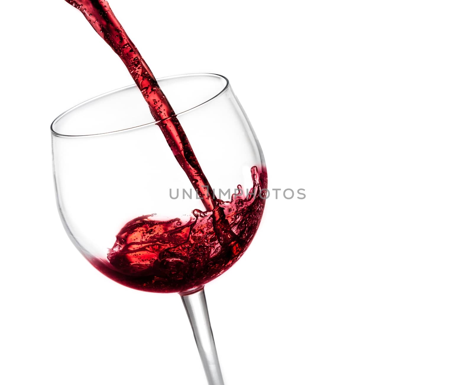 pouring red wine in the glass on white background