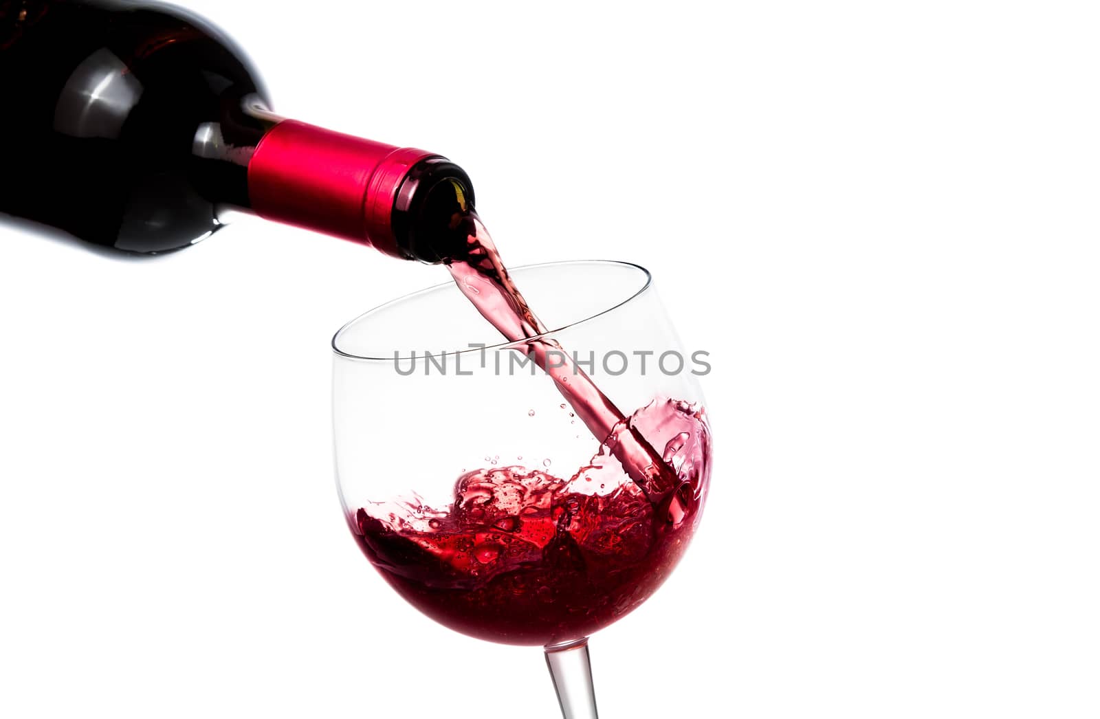 barman pouring red wine in the glass on white background