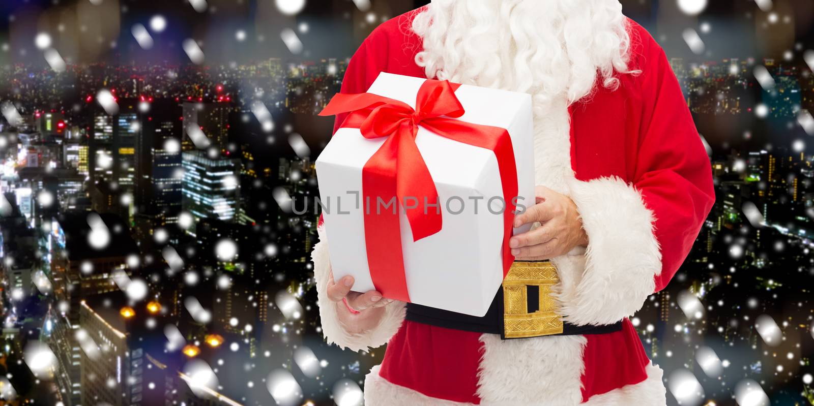 man in costume of santa claus with gift box by dolgachov