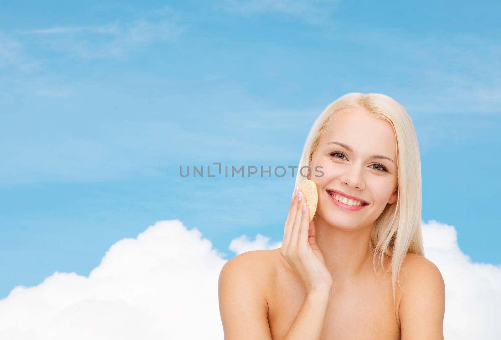 health, beauty and spa concept - beautiful woman with sponge
