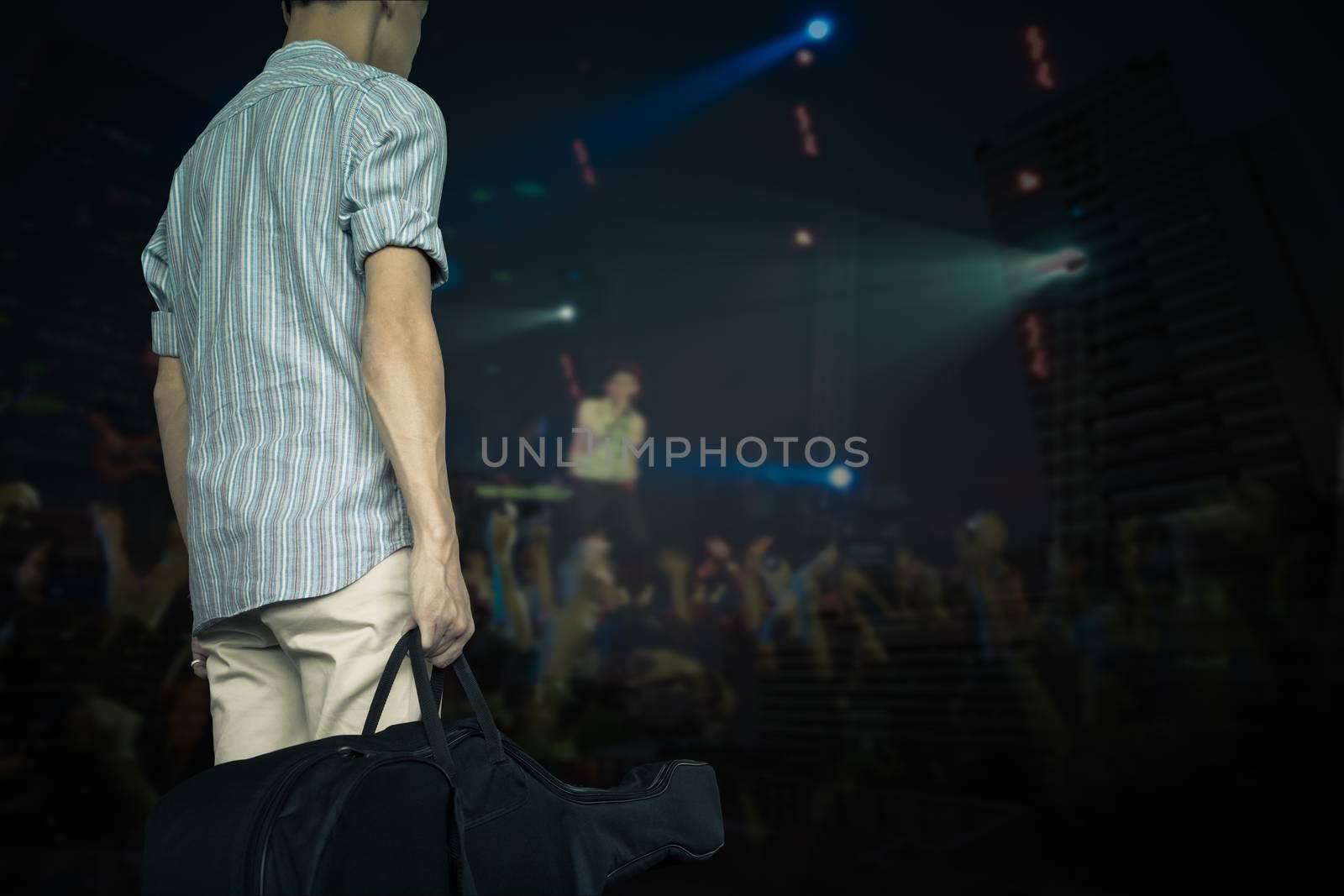 stylish young asian hipster man wear scott strip shirt, hold gui by FrameAngel