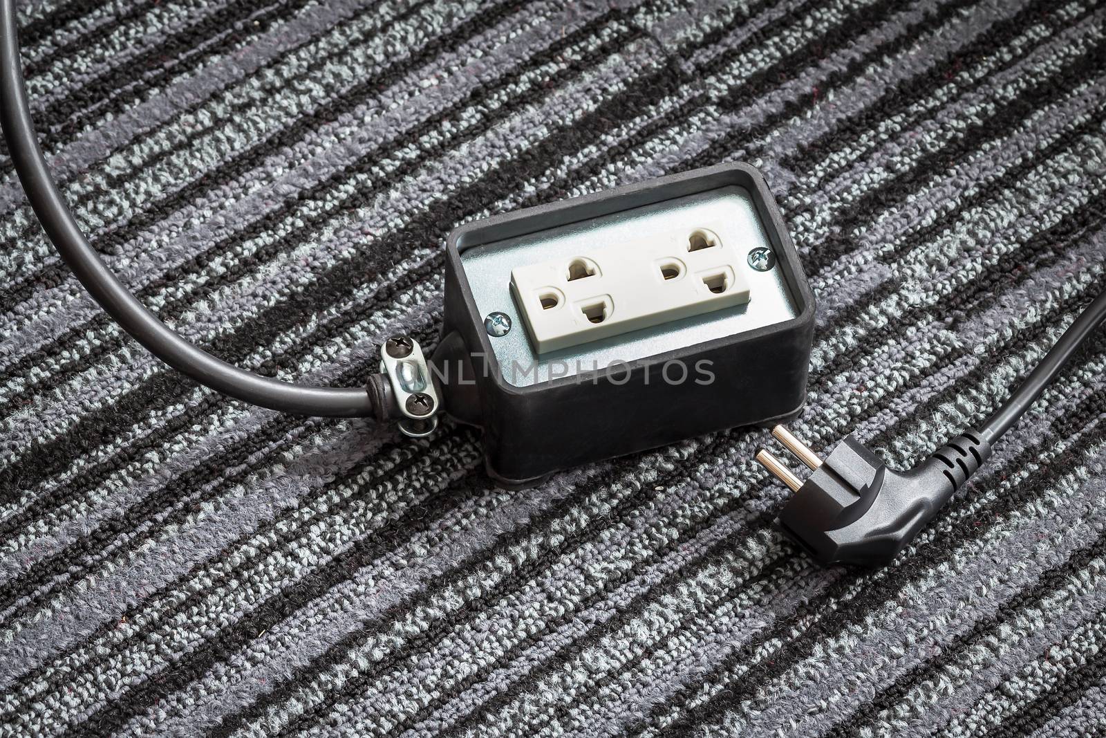 Electrical socket with power plug cable on carpet floor for safe by FrameAngel