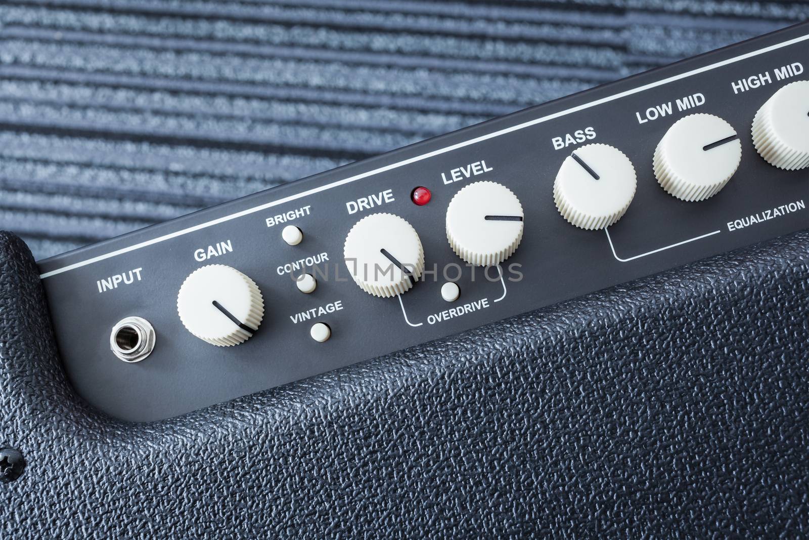 Button of Guitar Power Amplifier, closeup view background by FrameAngel