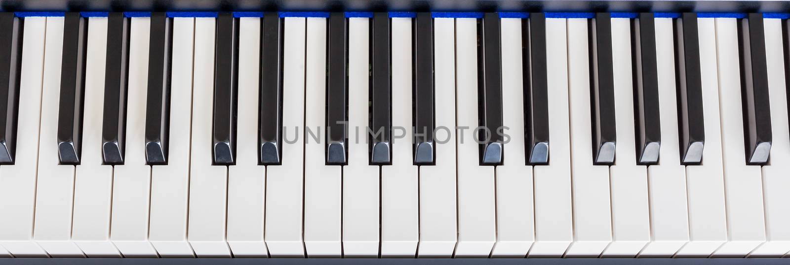 Piano Keyboard synthesizer closeup key top view by FrameAngel