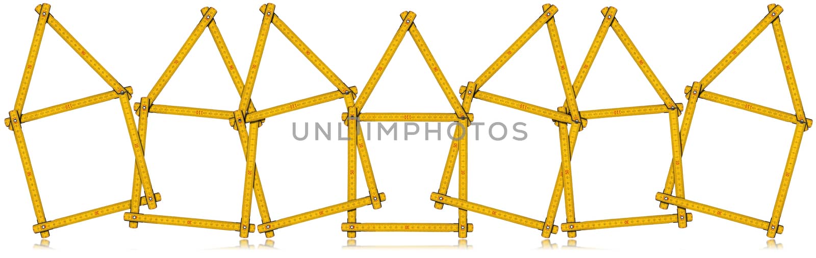 Seven wooden yellow meters in the shape of houses, isolated on white background. Design house concept