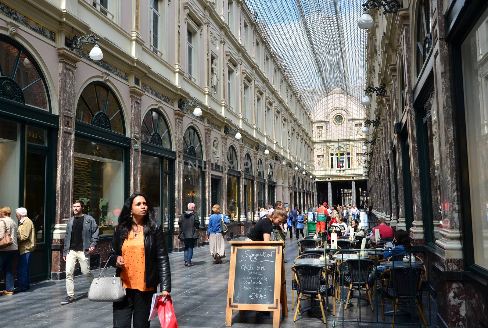 Brussels, Belgium - May 12, 2015: Tourists shopping at The Galeries Royales Saint-Hubert in Brussels, by siraanamwong