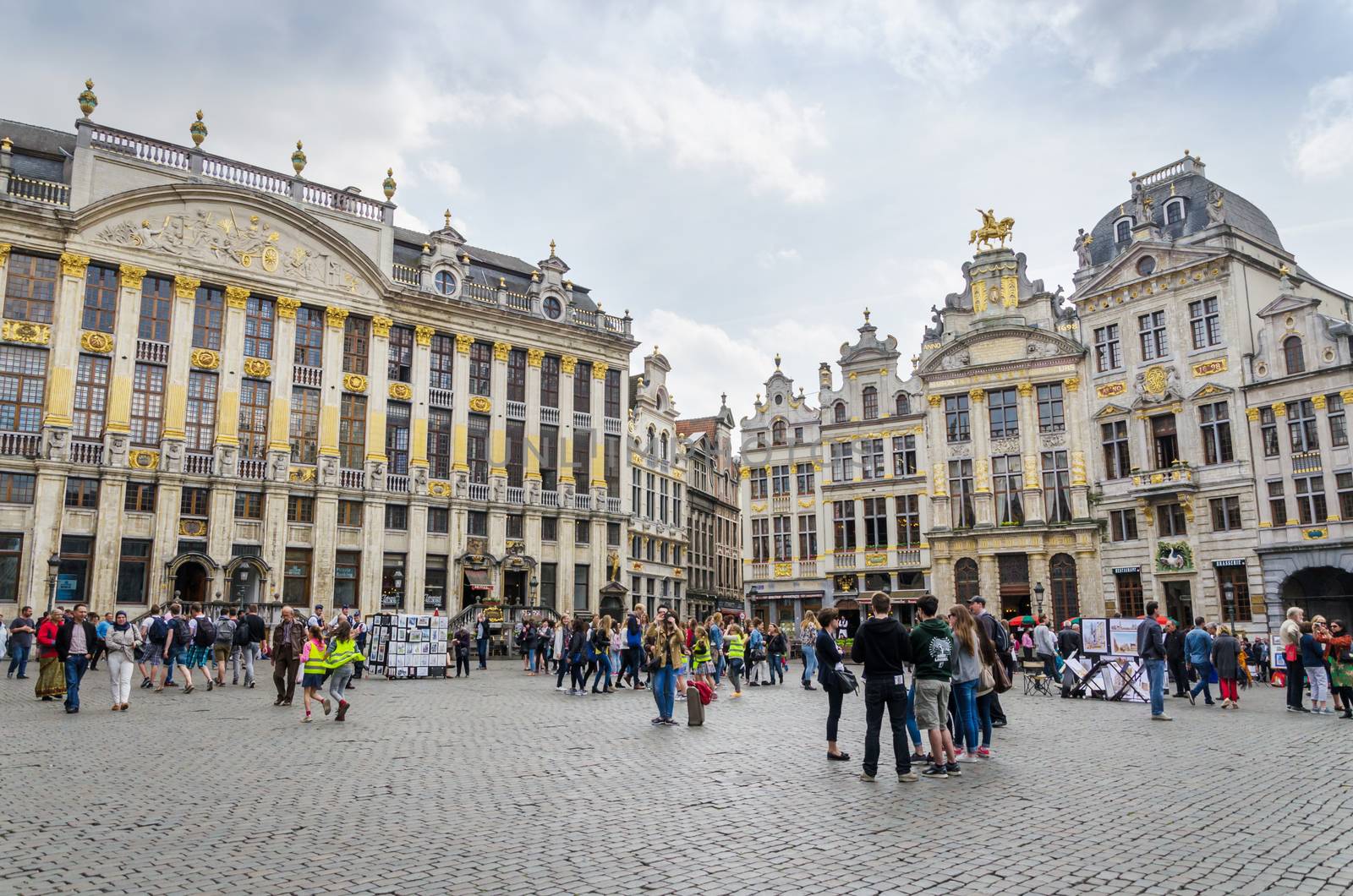 Brussels, Belgium - May 13, 2015: Many tourists visiting famous Grand Place (Grote Markt) the central square of Brussels. The square is the most important tourist destination and most memorable landmark in Brussels.