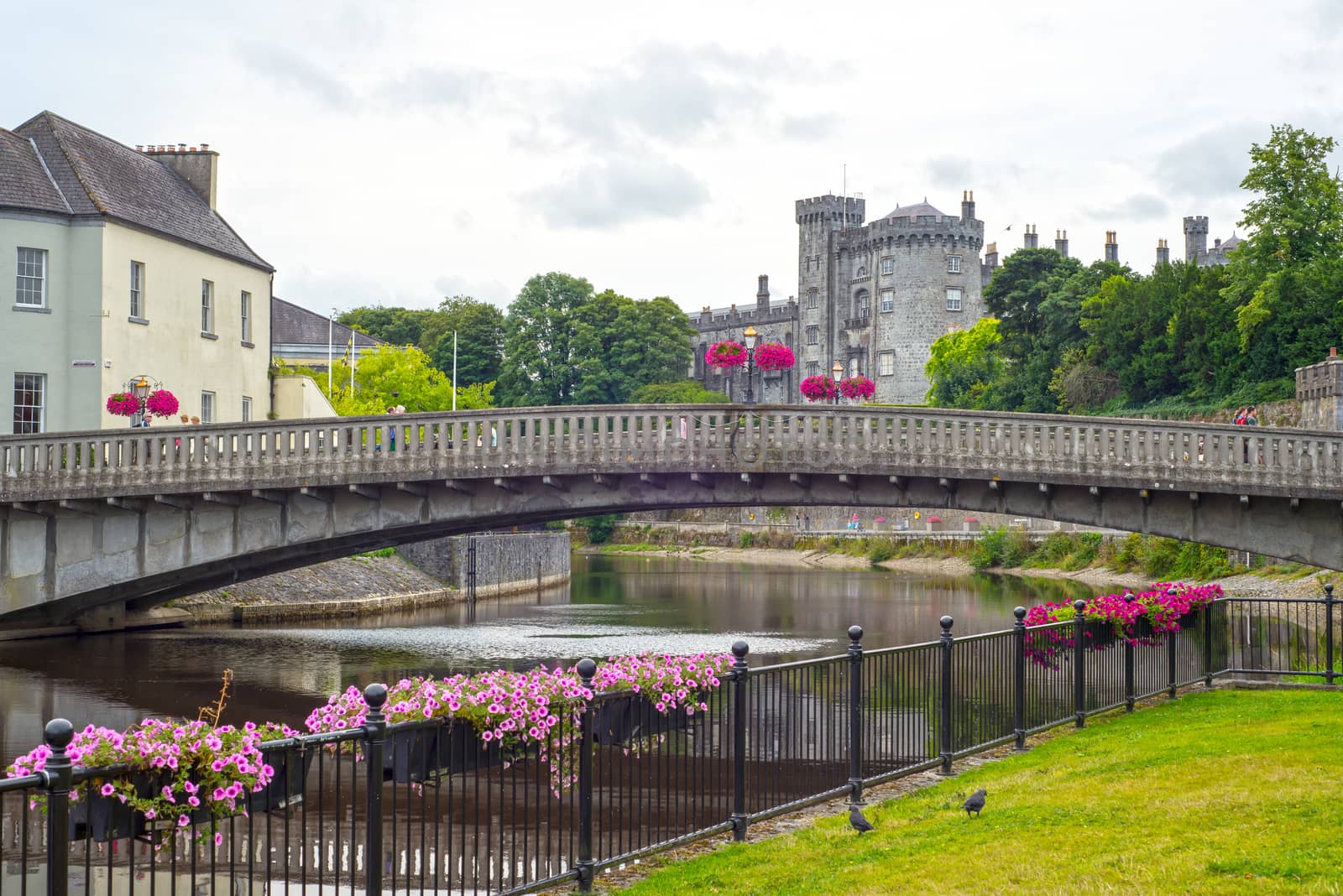 beautiful flower lined riverside railings view of kilkenny castle town and bridge