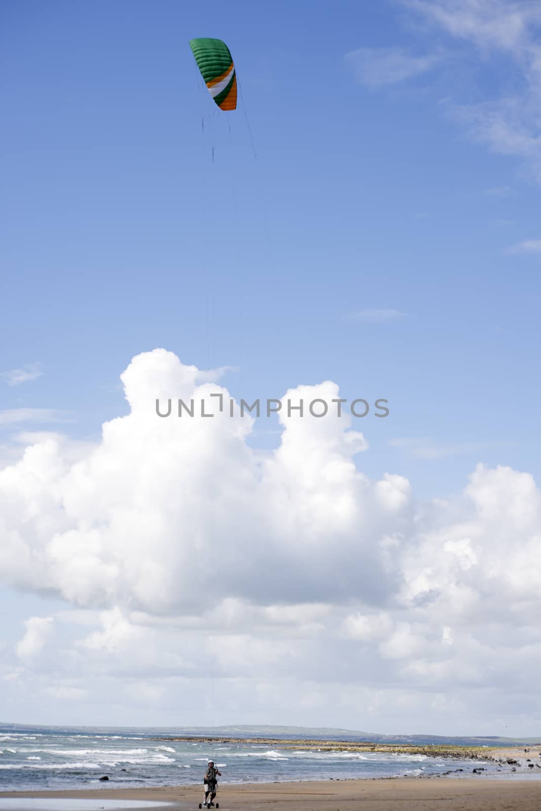 kite boarder on beautiful sandy beach by morrbyte