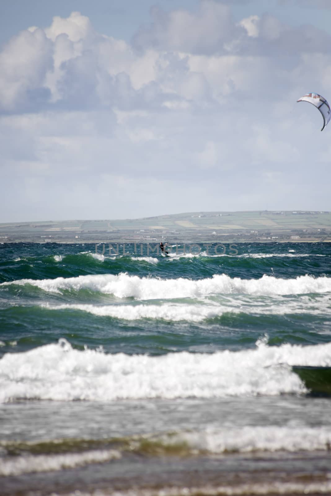 kite surfer on beautiful big waves by morrbyte