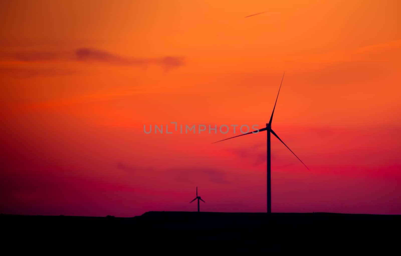 silhouette of  wind turbines at sunset by donfiore