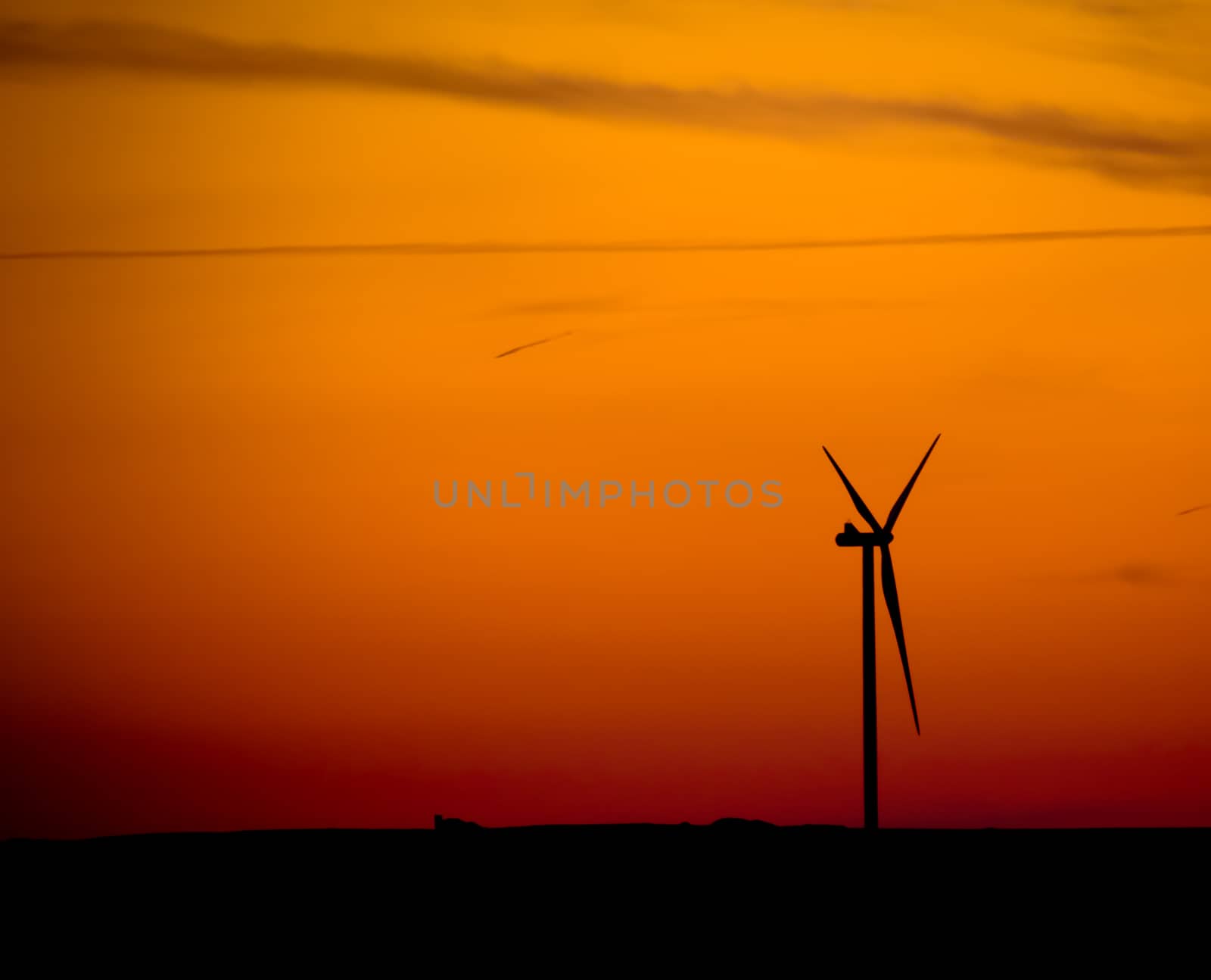 silhouette of  wind turbine at sunset, power and energy concept 