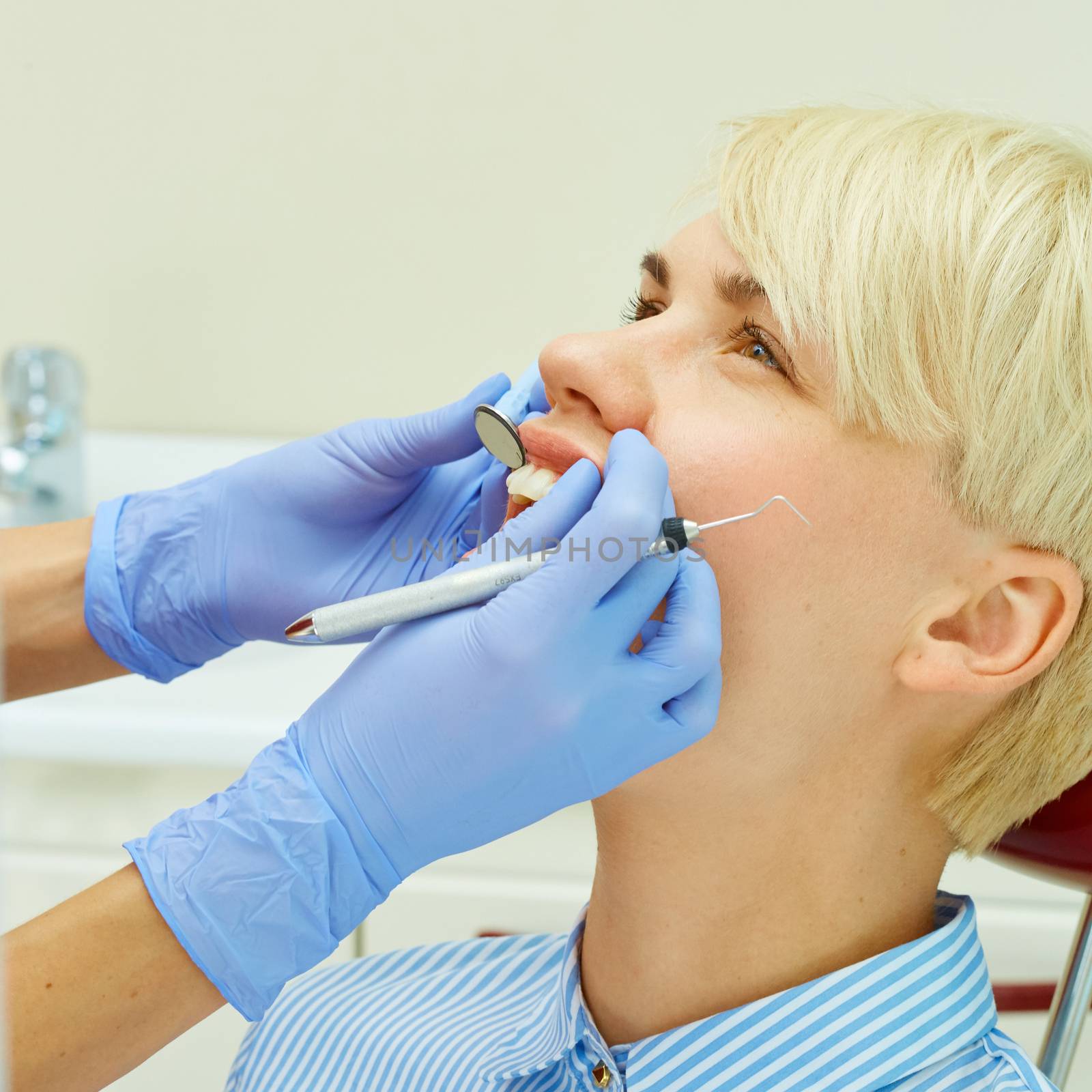 Dentist curing a female patient by sarymsakov