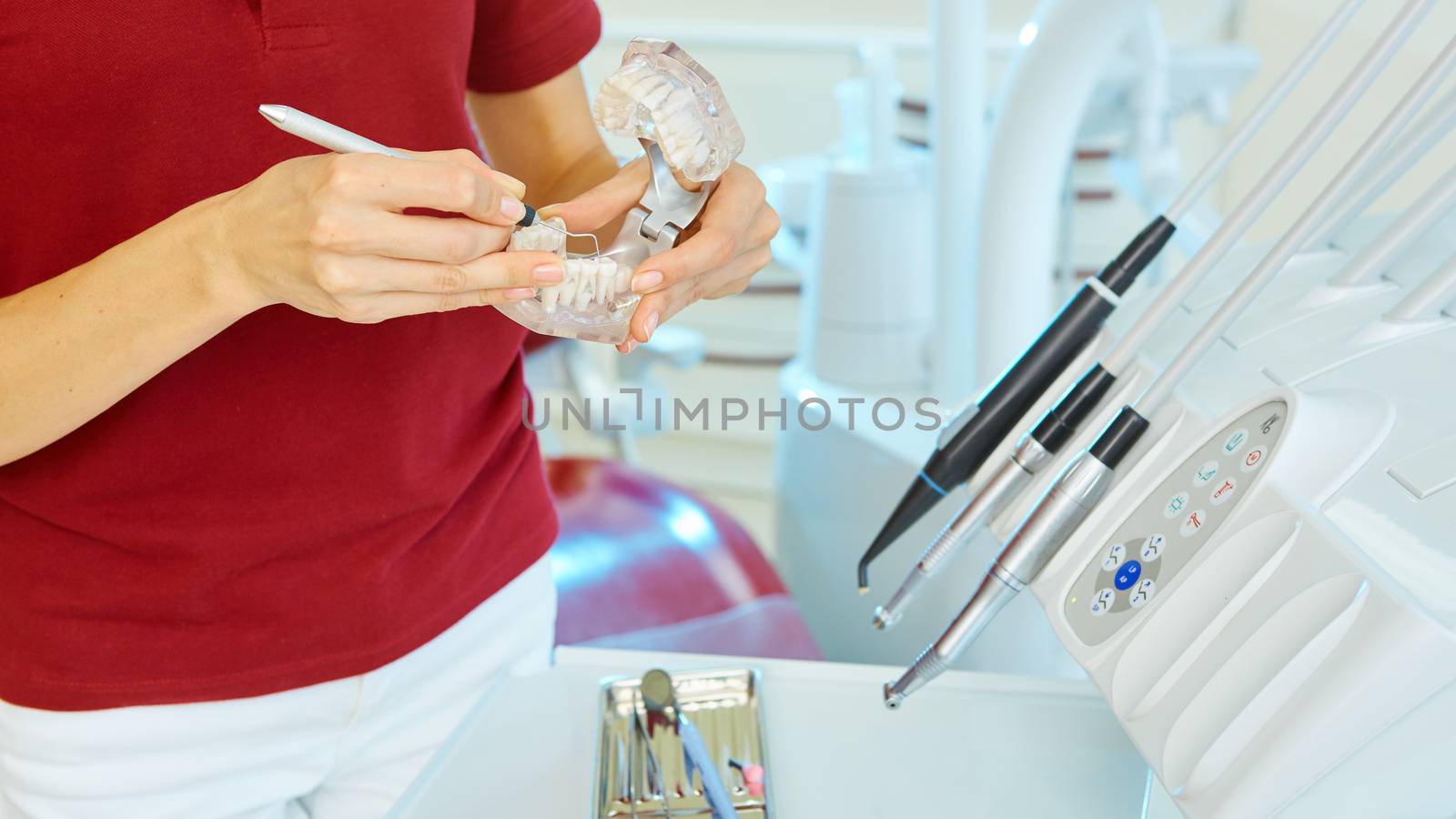 hands of dentist holding his tools during patient examination