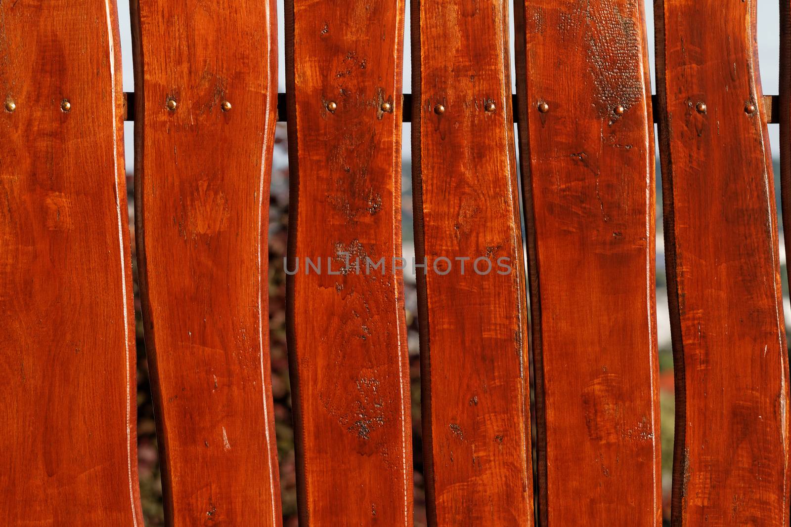 Photo of a brown freshly painted wooden fence