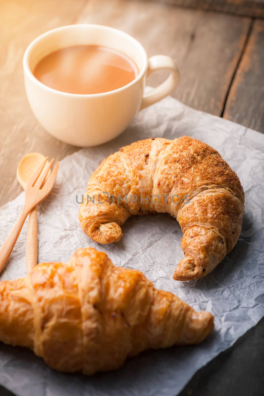 Butter croissant and whole wheat croissant on wood table with morning scene