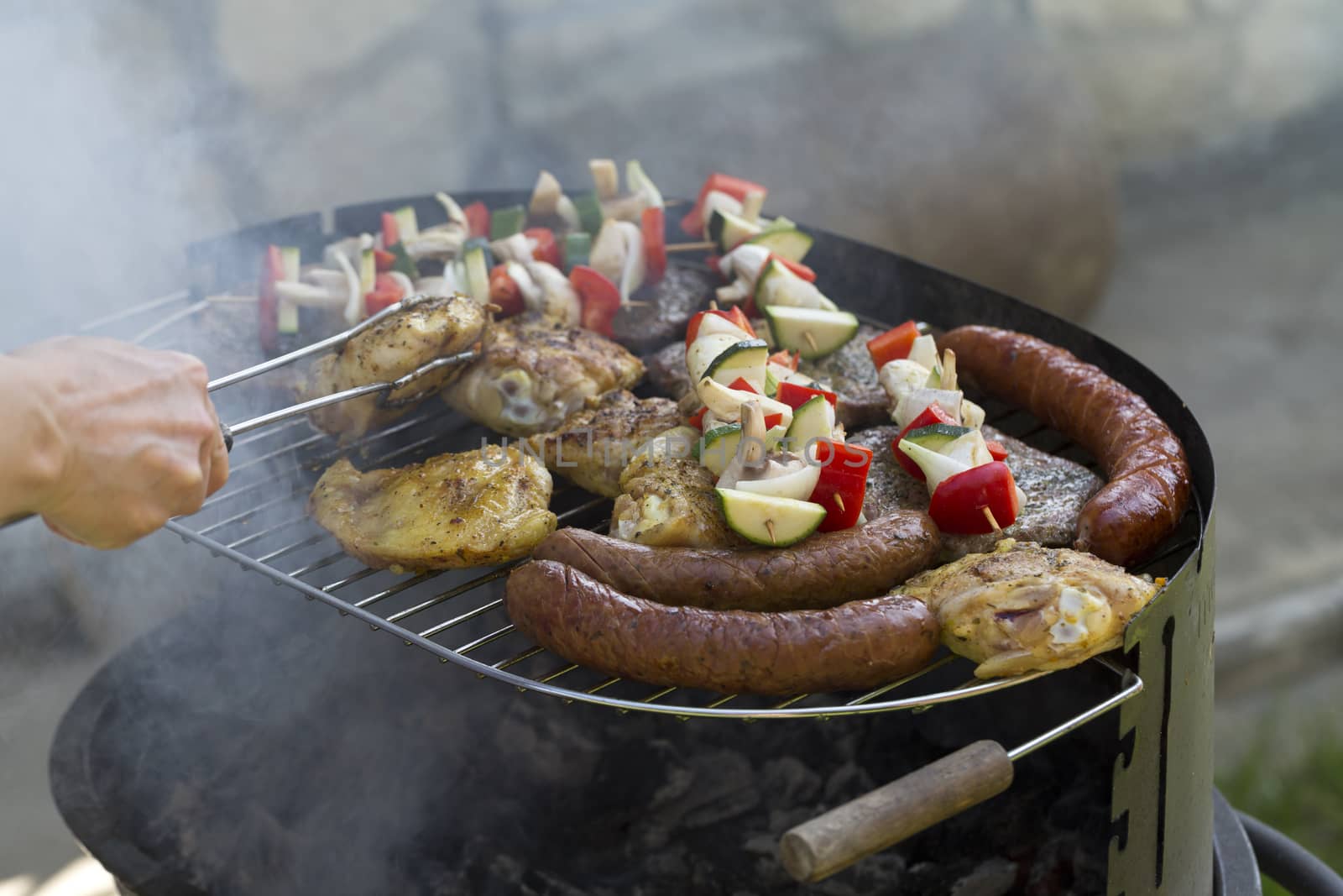 barbecue with delicious grilled meat and vegetables on grill  by wjarek