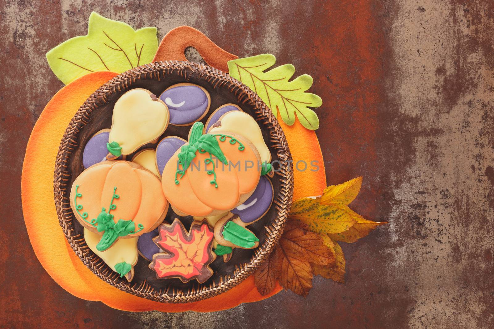 Thanksgiving cookies in the shape of pumpkin, pear, plum and leaves. Fall decorated cookies