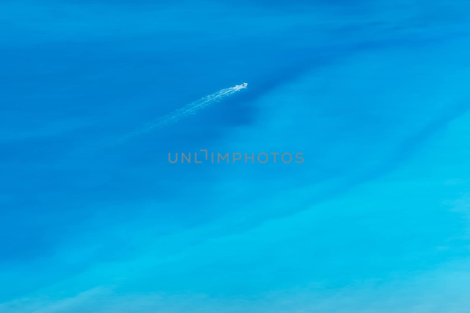 Aerial view of turquoise sea with motor boat