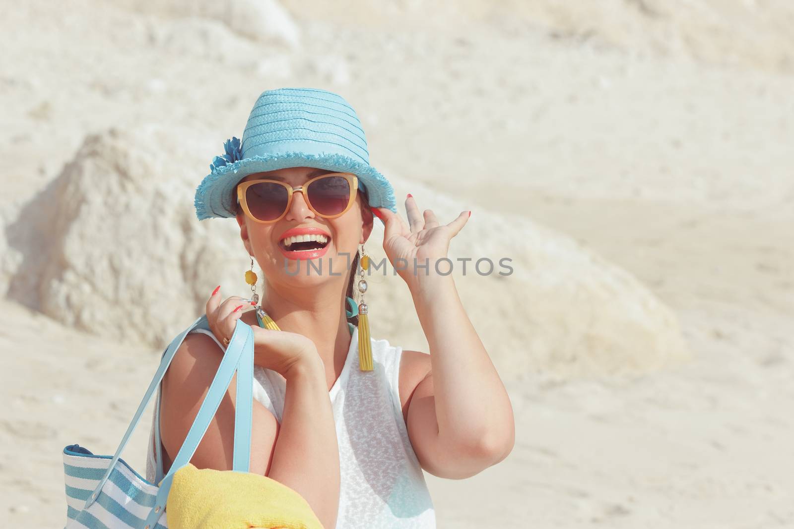 Woman with towel bag on the sandy beach. by Slast20