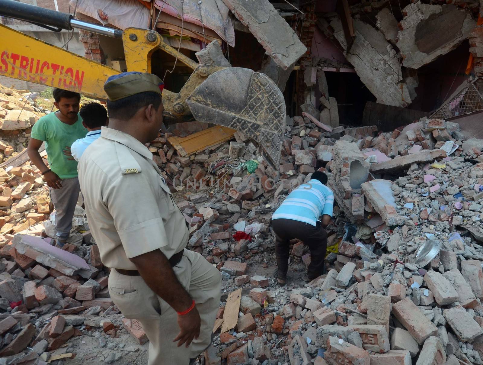 INDIA, Allahabad: Police conduct rescue work, trying to save or recover anyone in the debris of two houses which collapsed on October 6, 2015, after an explosion at a firecracker factory. According to our contributor on the ground, the firecracker factory was operating illegally.