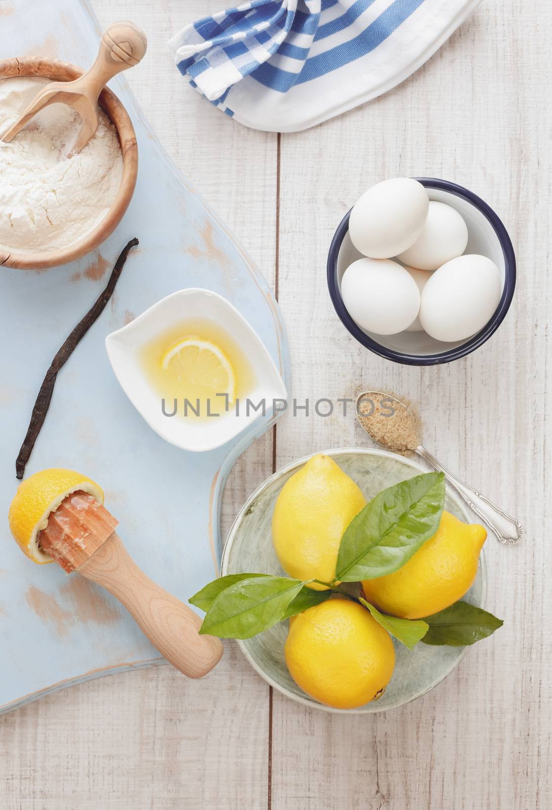 Ingredients for lemon cake on wooden table, vintage style, top view. Natural light