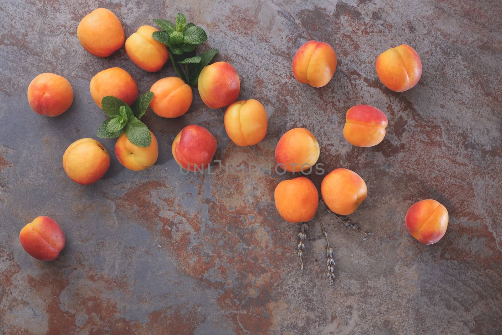 Still life of fresh apricots on a rustic stone surface, top view, rustic style. Natural light