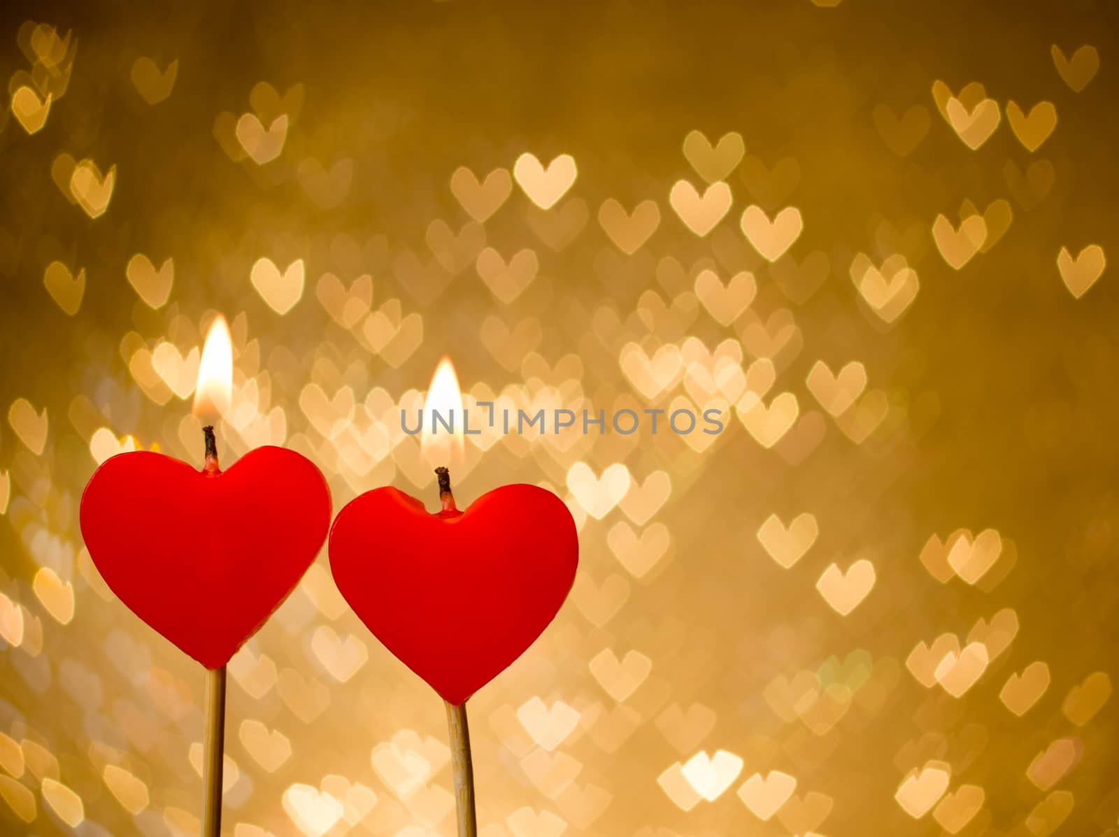 red hearts candles on golden hearts bokeh as background by donfiore