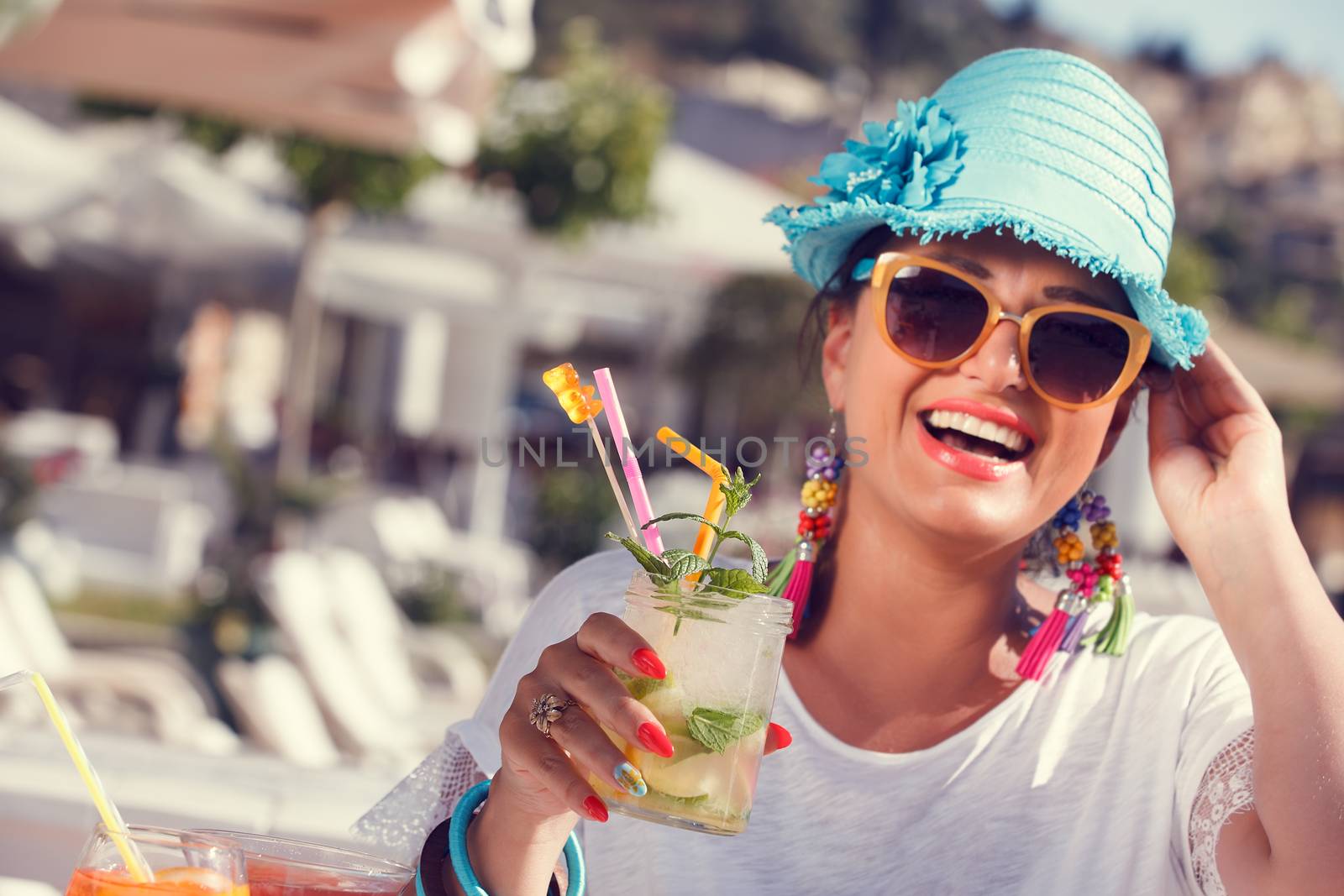 Beautiful happy woman enjoying in summer cocktail, near the yacht marine.Vintage style, selective focus
