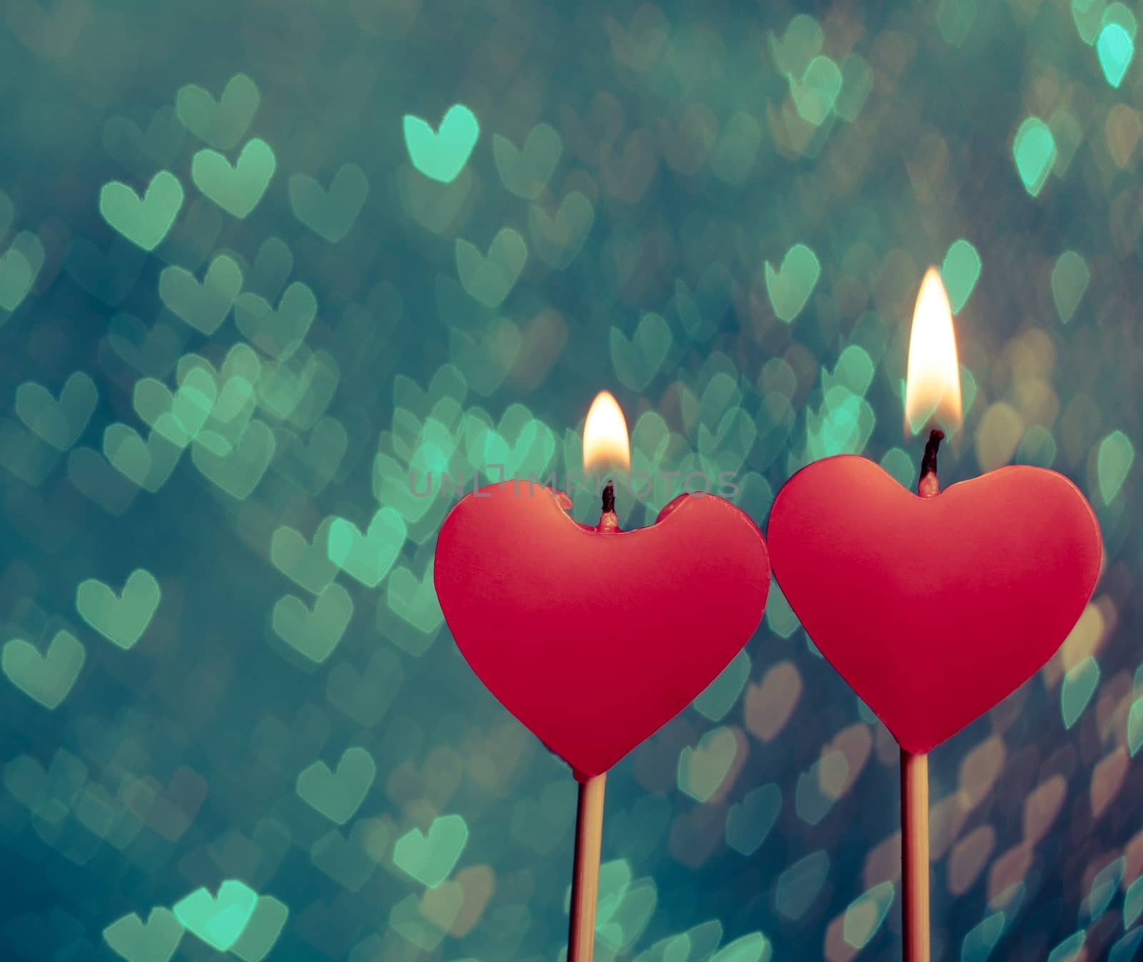 red hearts candles on vintage hearts bokeh as background by donfiore
