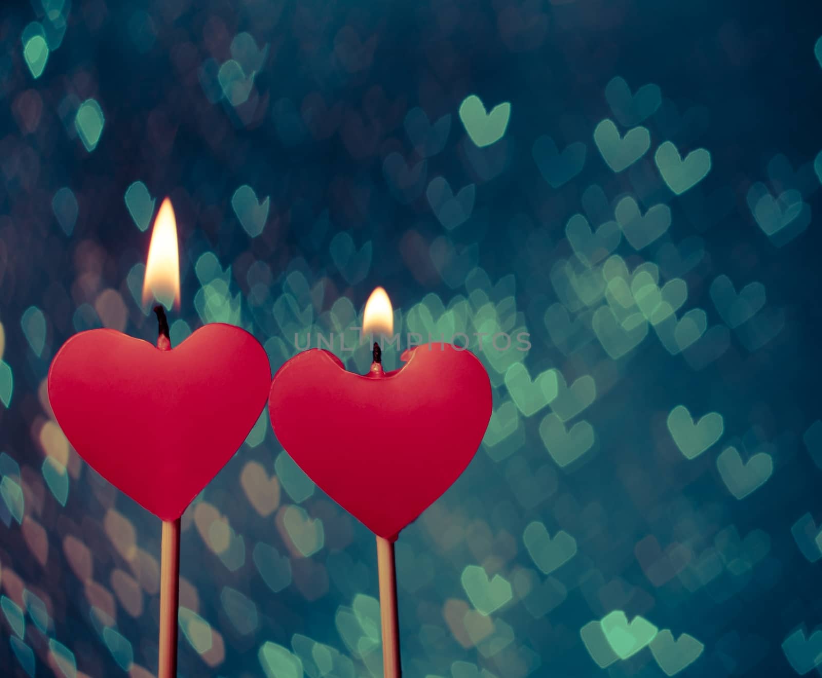 red hearts candles on vintage hearts bokeh as background by donfiore
