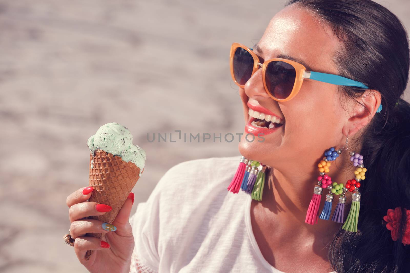 Happy woman enjoying in matcha mint chip ice cream. Focus on the ice cream