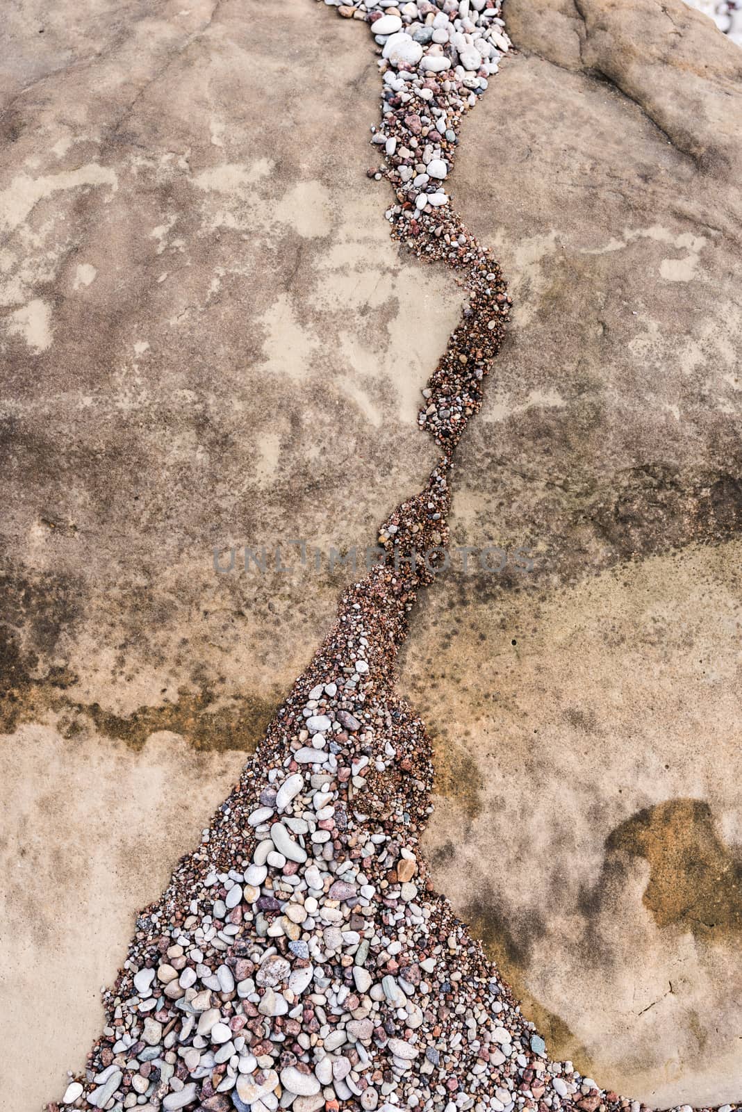 A lot of small stones on the surface of boulder