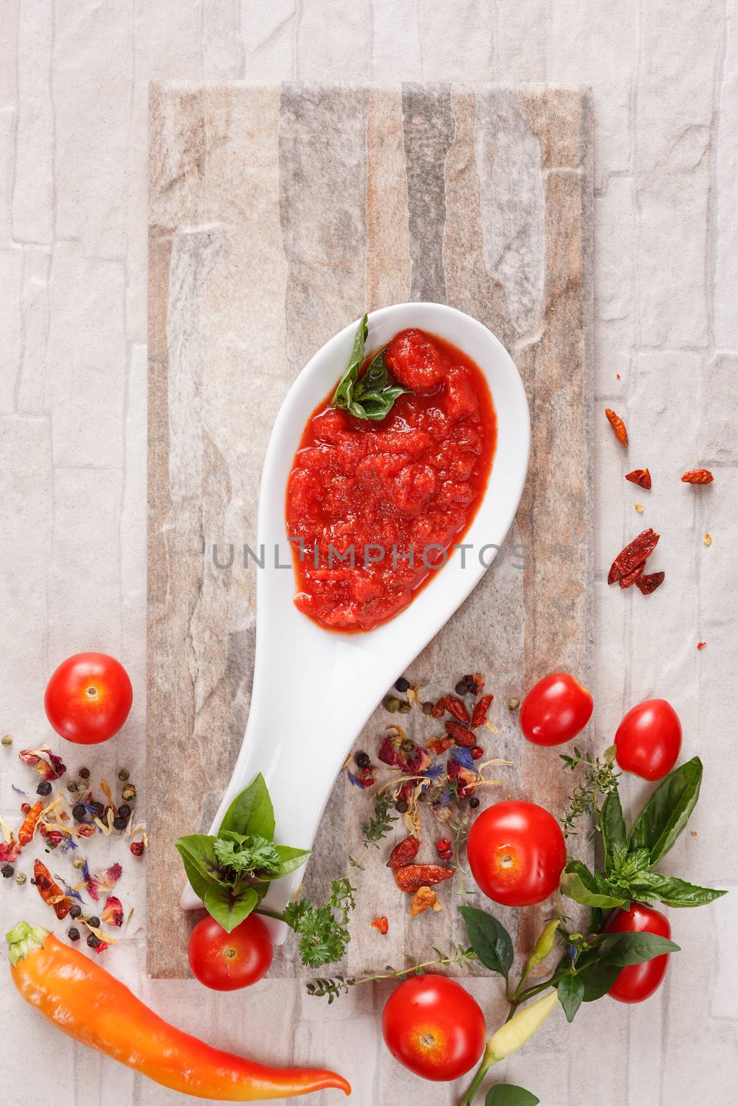 Tomato and roasted pepper chutney on spoon, top niew