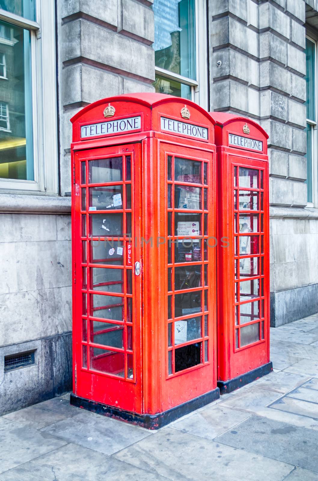 Classic British red phone booth in London by marcorubino