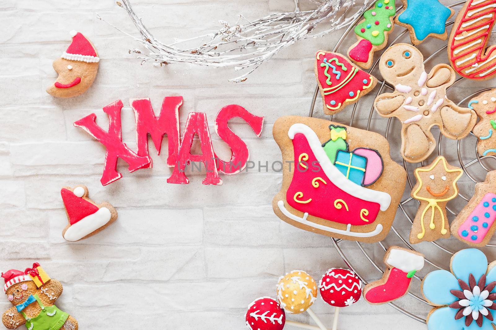Various types of Christmas decorative cookies decorated with sugar icing on cooling rack