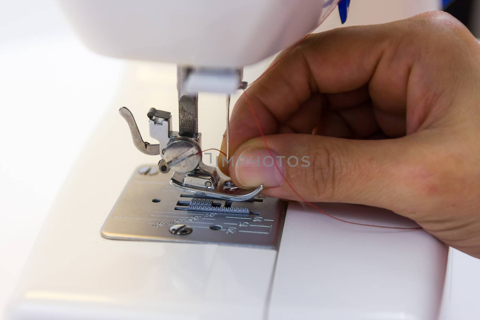seamstress while working with the sewing machine