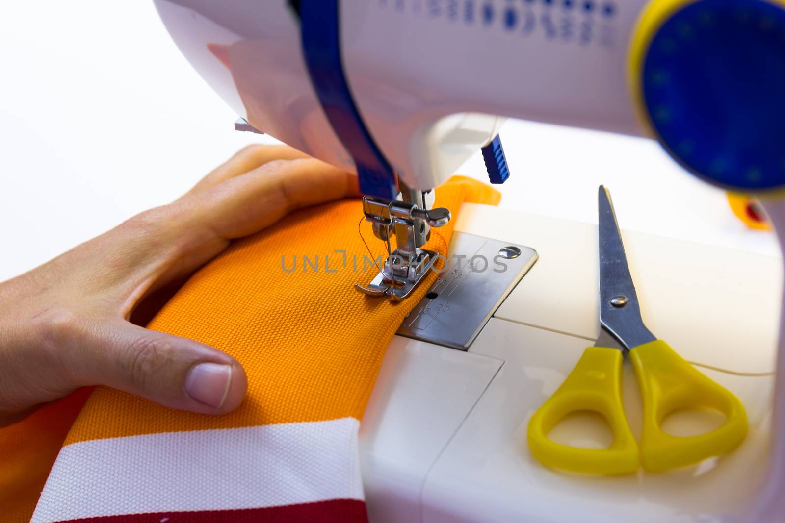 seamstress while working with the sewing machine