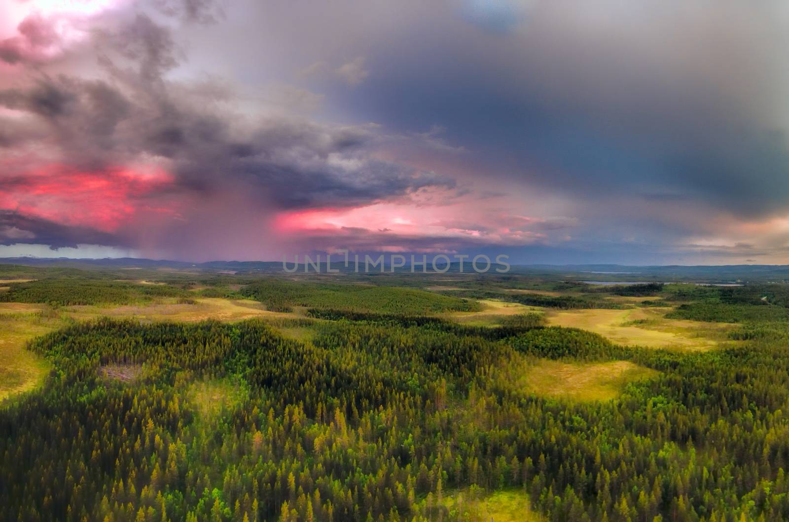 Aerial view of storms forming above the swedish lapland during sunset