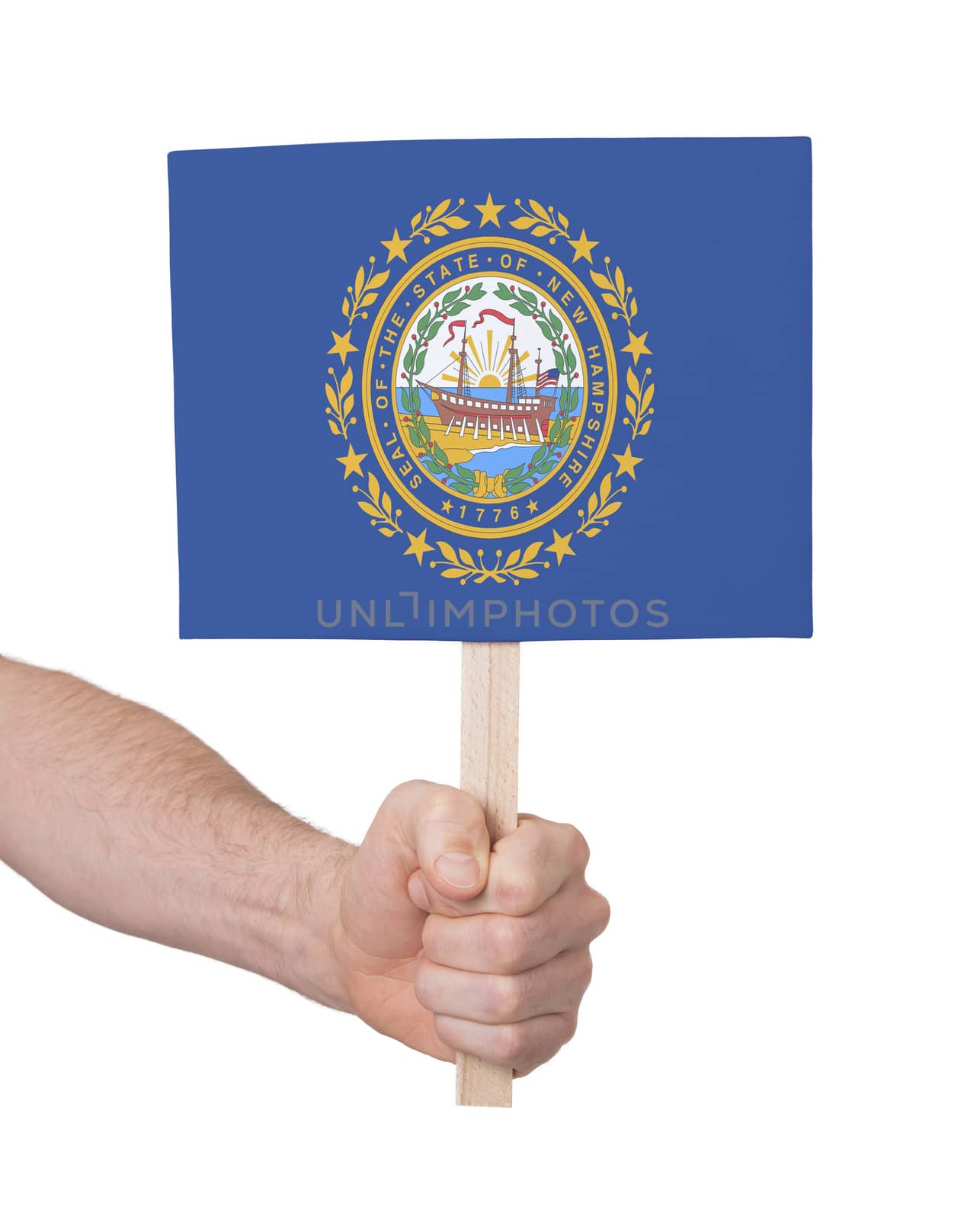 Hand holding small card, isolated on white - Flag of New Hampshire