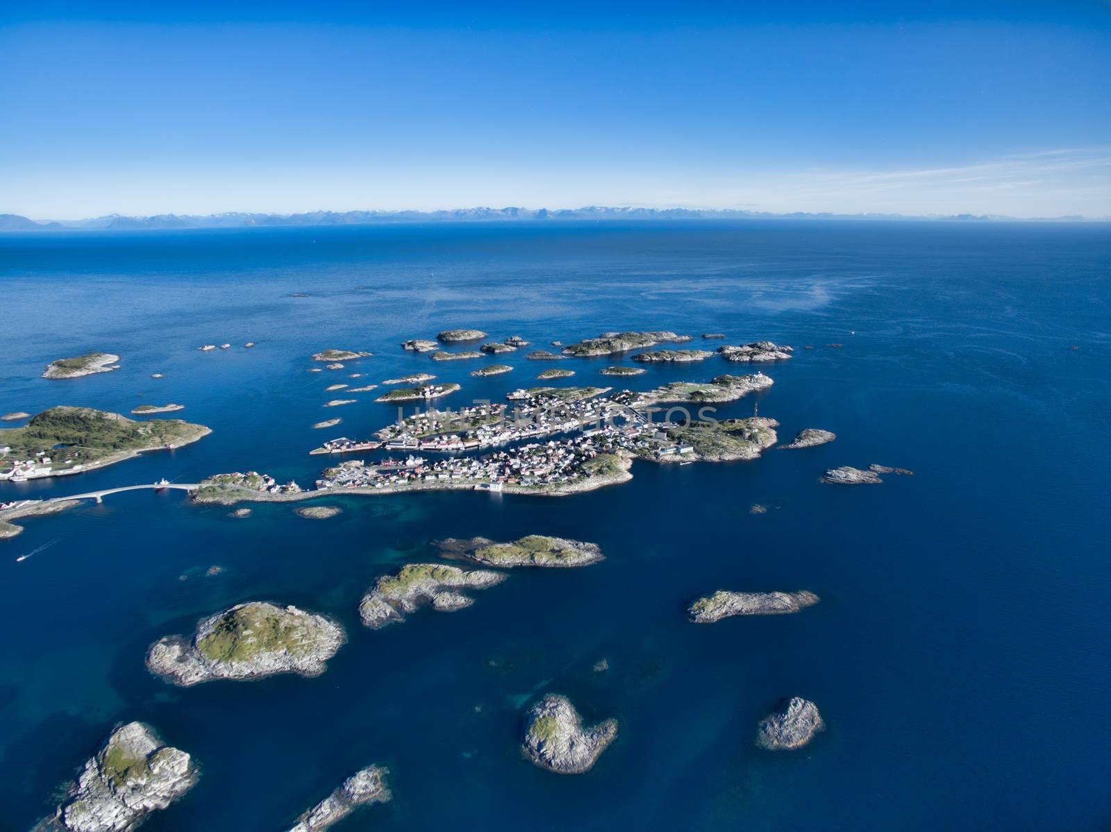 Aerial view of picturesque fishing port Henningsvaer on small islets in the sea