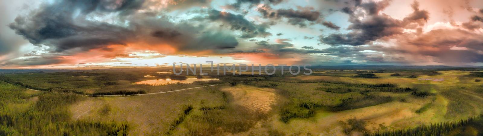 Aerial panorama of huge storm clouds during sunset over the forests in Sweden