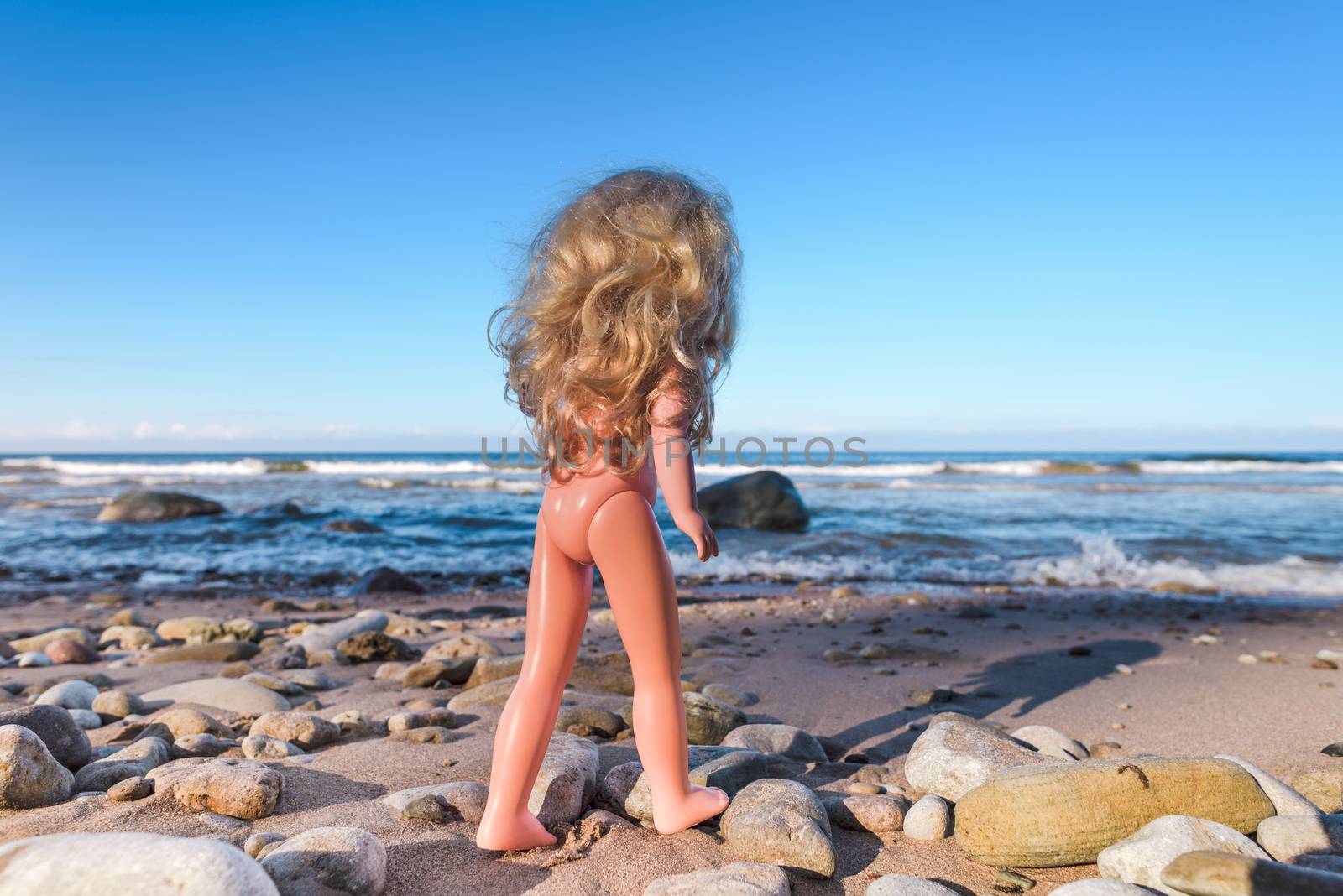 Plastic baby doll on the seashore