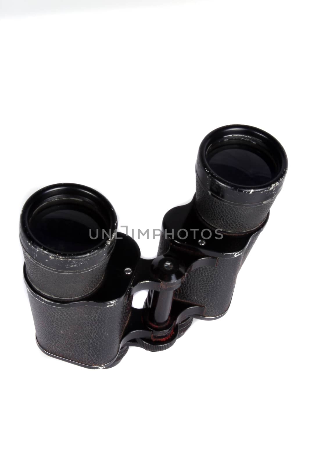 A pair of antique binoculars used in World War 1, on white studio background.