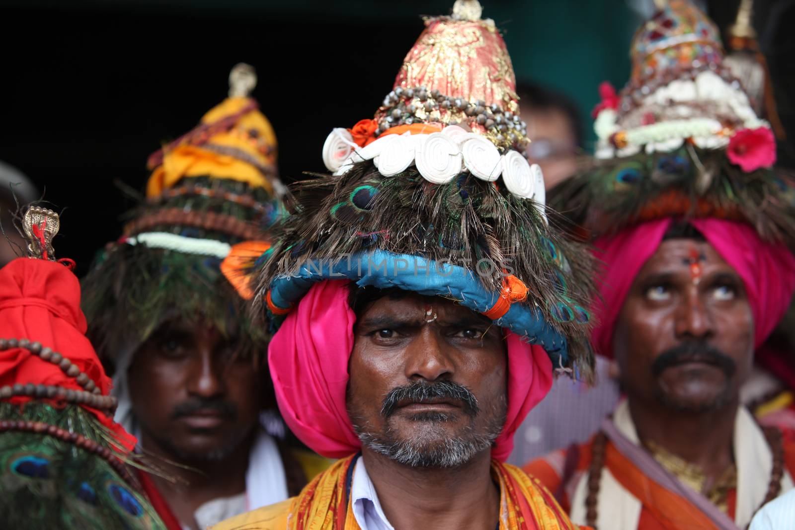 Pune, India - July 11, 2015: A group of Vasudev pilgrims who are devotees of Lord Vishnu and wear a conical hat with peacock feathers. Vasudev has been a traditional since many years in Maharashtra. THese pilgrims go around singing praises of Lord Vishnu.