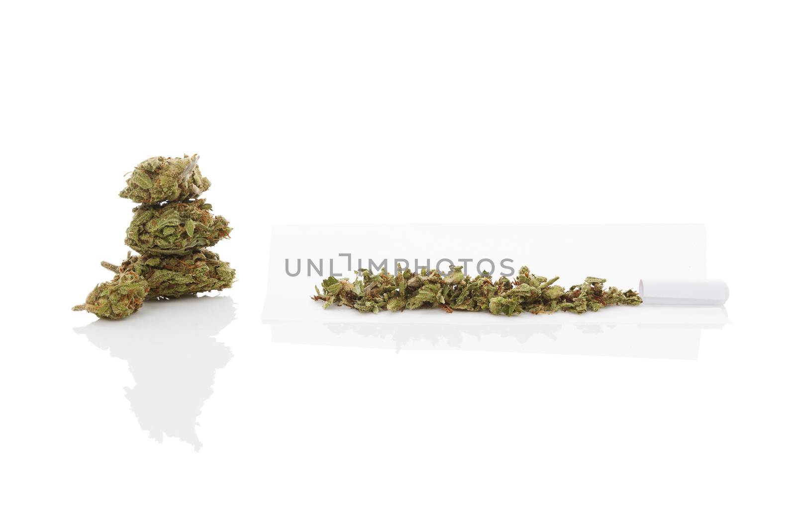 Smoking marijuana. Cannabis abuse. Marijuana bud and rolled joint isolated on white background. 